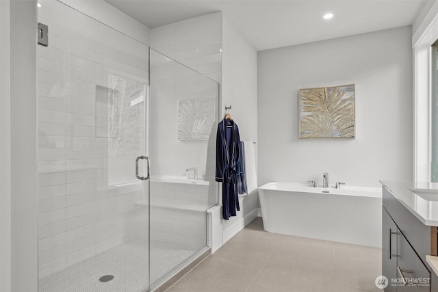 full bathroom with a freestanding tub, recessed lighting, vanity, a shower stall, and tile patterned floors