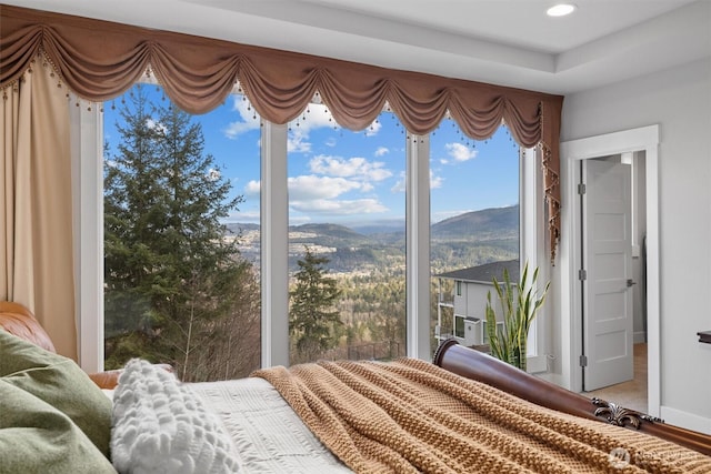 bedroom featuring baseboards, a mountain view, and recessed lighting