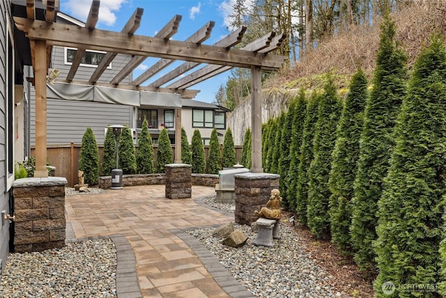 view of patio with fence, a pergola, and area for grilling