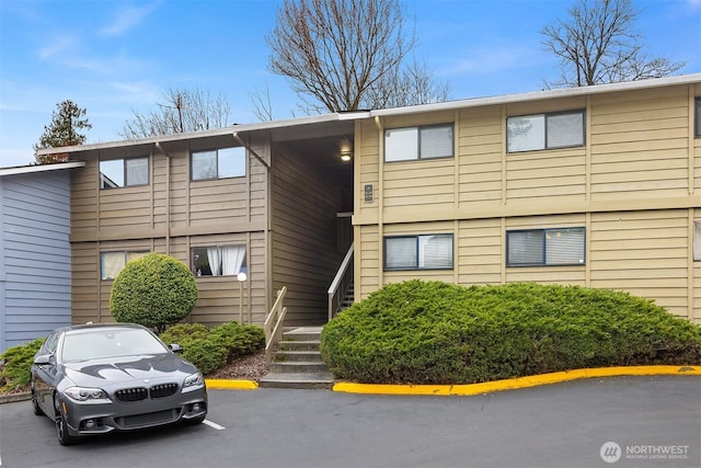 view of building exterior featuring uncovered parking