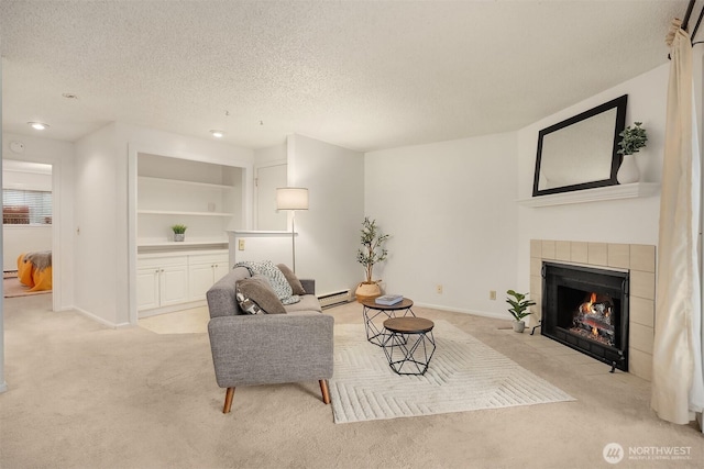 carpeted living room with a fireplace, baseboards, baseboard heating, and a textured ceiling