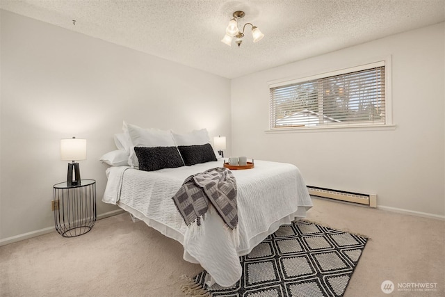 carpeted bedroom with a textured ceiling, a baseboard radiator, and baseboards