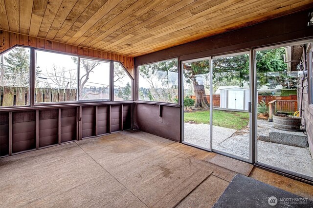 unfurnished sunroom featuring wood ceiling