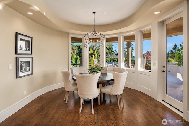 dining room featuring dark wood finished floors, recessed lighting, baseboards, and an inviting chandelier