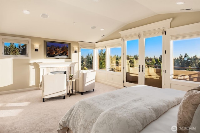 bedroom featuring visible vents, access to exterior, vaulted ceiling, light carpet, and a tiled fireplace