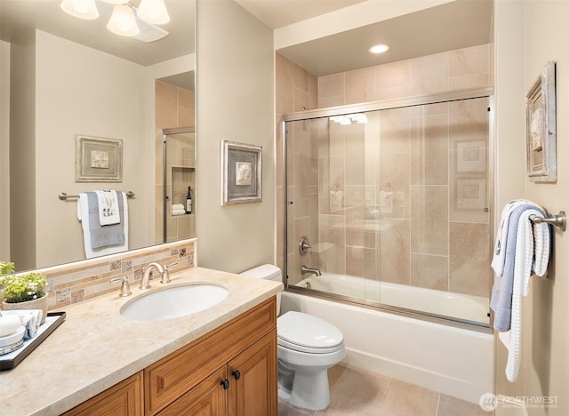 full bath featuring vanity, toilet, tile patterned flooring, and bath / shower combo with glass door