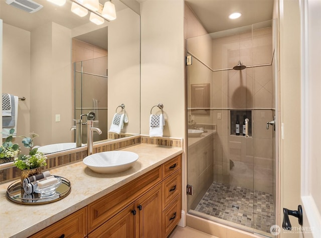 full bathroom featuring recessed lighting, visible vents, vanity, and a shower stall