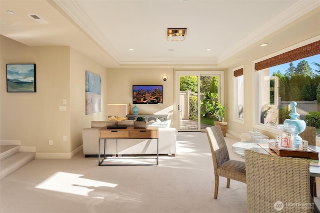 interior space featuring carpet, baseboards, visible vents, a tray ceiling, and ornamental molding