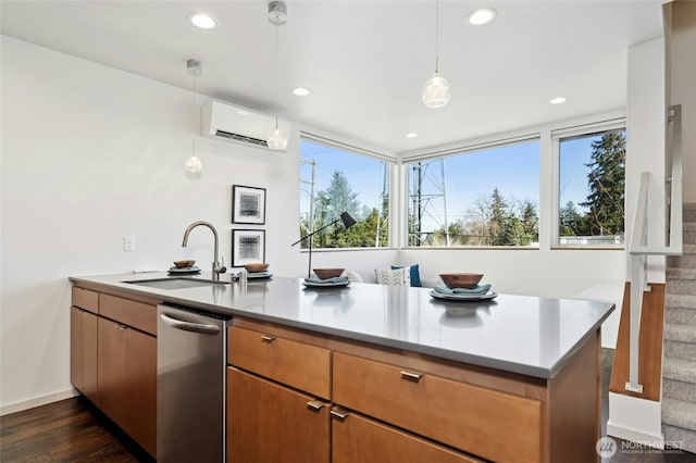 kitchen with a peninsula, dark wood-type flooring, a sink, a wall mounted AC, and dishwasher