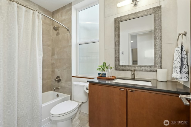 bathroom with tile patterned flooring, shower / bath combo, vanity, and toilet