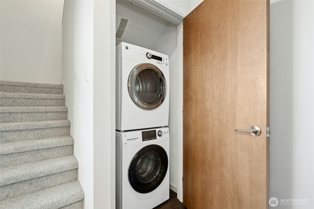 washroom featuring laundry area and stacked washer / drying machine