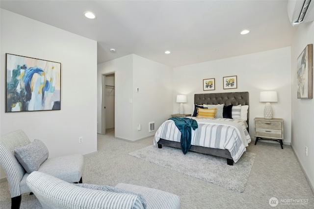 bedroom with recessed lighting, a wall mounted air conditioner, and light carpet