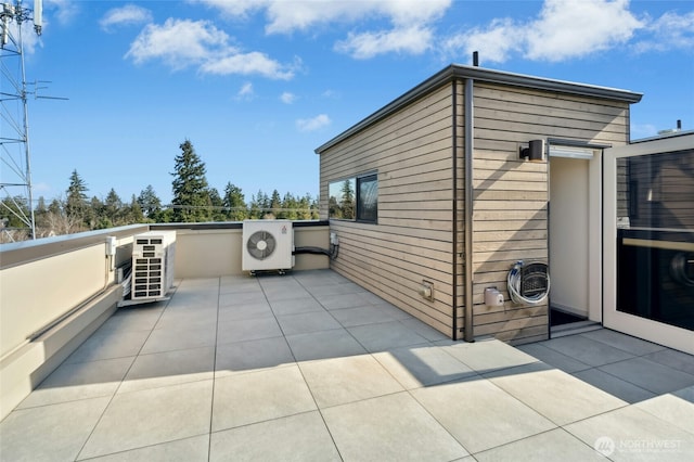 view of patio featuring ac unit and a balcony