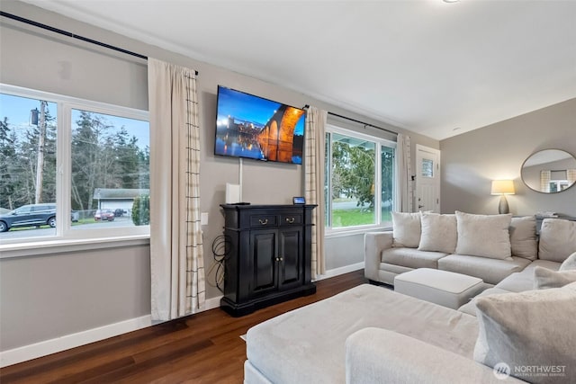 living area featuring lofted ceiling, dark wood-style flooring, and baseboards