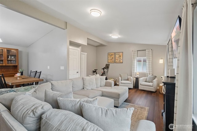 living room with vaulted ceiling with beams and dark wood finished floors