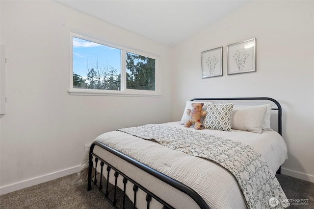 bedroom with vaulted ceiling, carpet floors, and baseboards