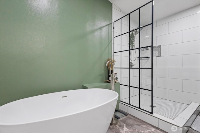 full bathroom with a soaking tub and a shower stall