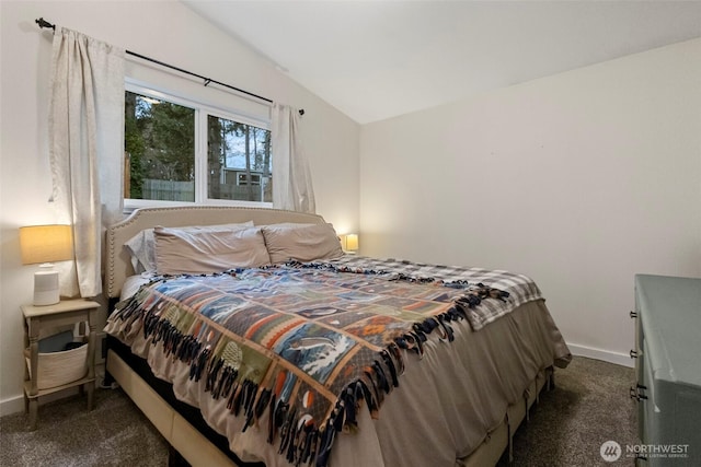 carpeted bedroom featuring baseboards and vaulted ceiling