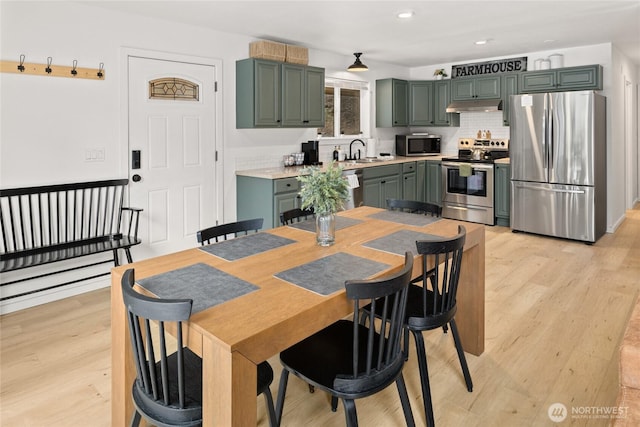 dining space featuring light wood-type flooring and recessed lighting