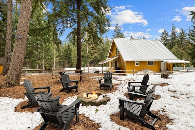 exterior space featuring fence and a fire pit