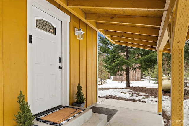 view of snow covered property entrance