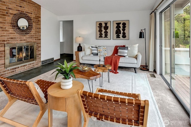 living room with a brick fireplace