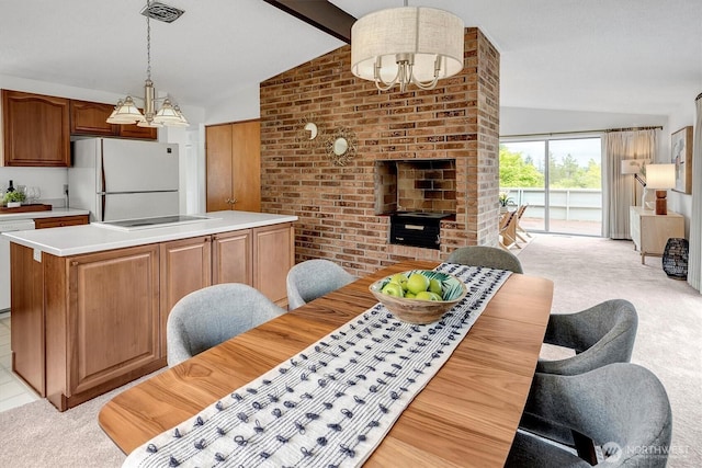 dining space with light carpet and a chandelier