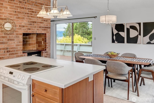 kitchen featuring white electric stove, a chandelier, light countertops, pendant lighting, and brown cabinetry
