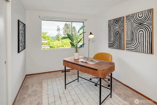 office space featuring light colored carpet and baseboards