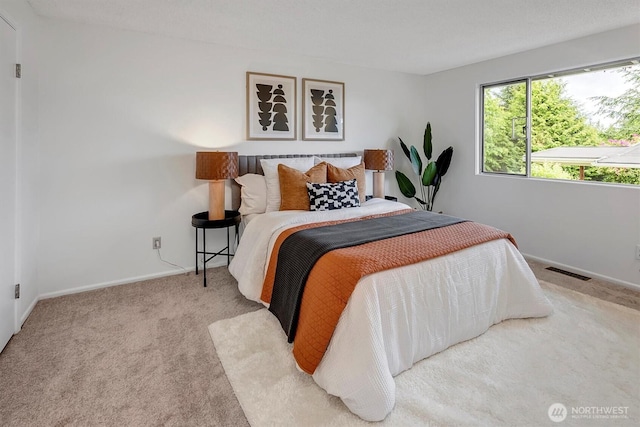 bedroom with carpet floors and baseboards