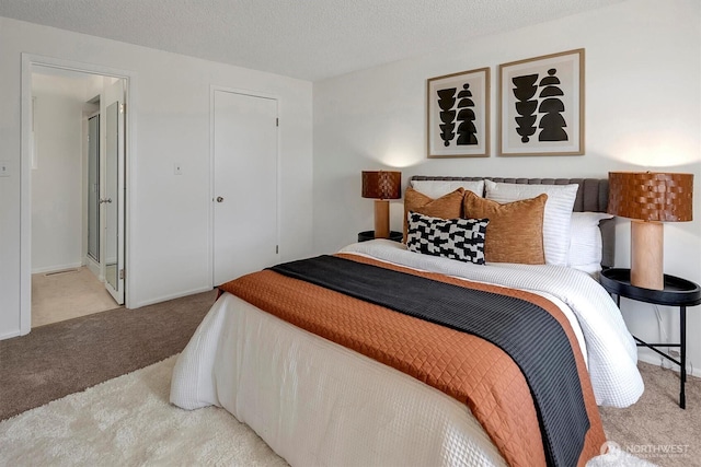 bedroom with carpet floors, a closet, and connected bathroom