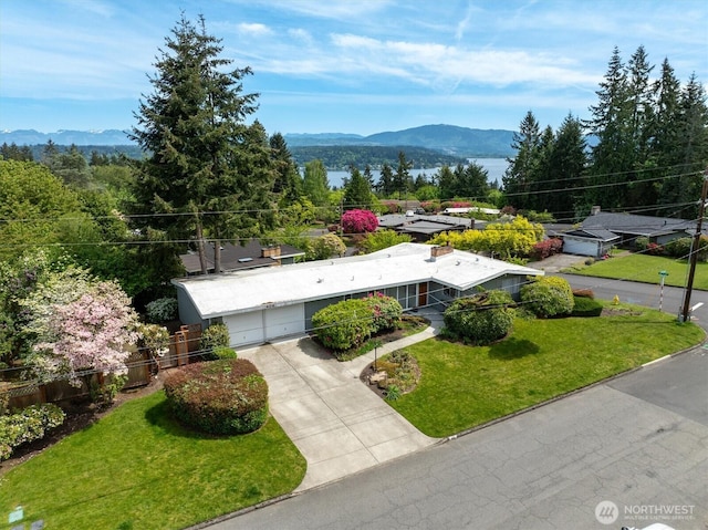 aerial view of property and surrounding area with mountains