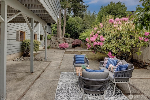 view of patio / terrace featuring outdoor lounge area and fence