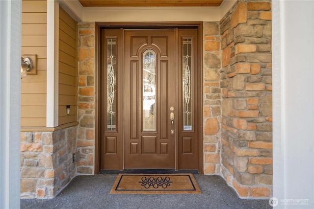 property entrance with stone siding