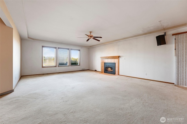 unfurnished living room with carpet, a fireplace, baseboards, and ceiling fan