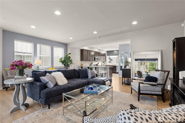 living room with recessed lighting and light wood-type flooring