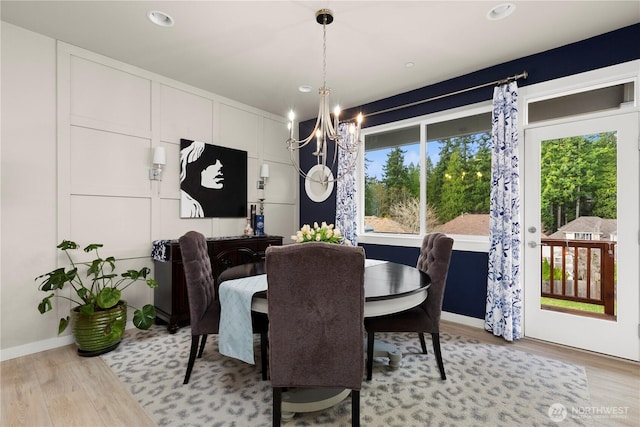 dining space featuring recessed lighting, baseboards, light wood finished floors, and a chandelier