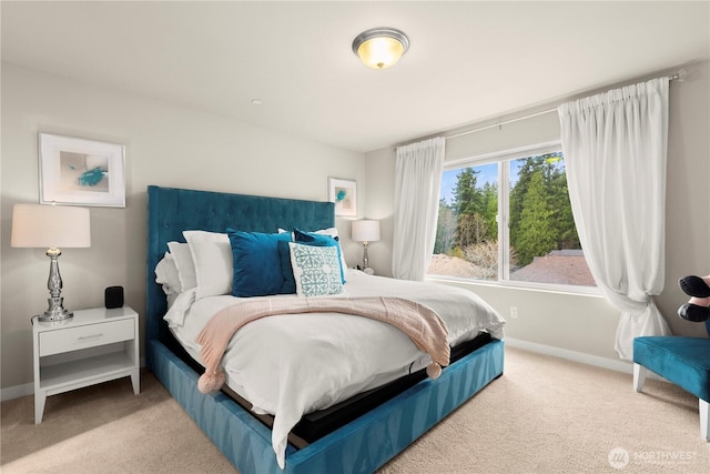 bedroom featuring baseboards and carpet