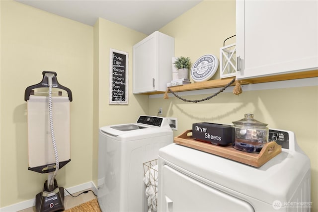 washroom with cabinet space, baseboards, and washer and clothes dryer