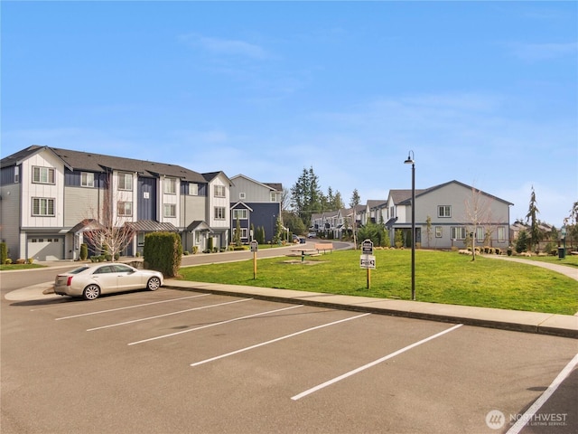 uncovered parking lot featuring a residential view