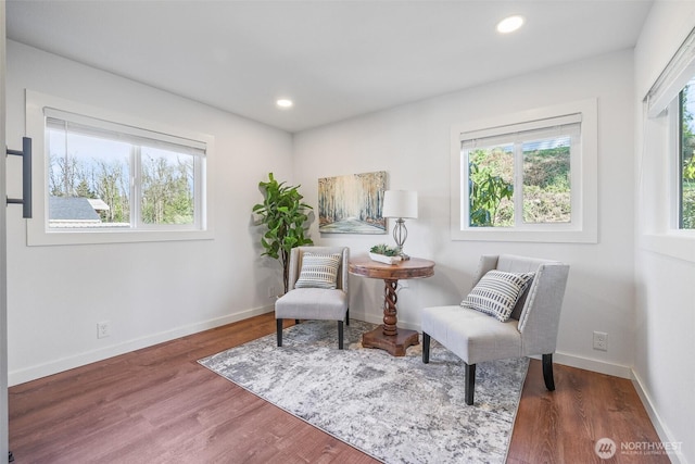 living area featuring a wealth of natural light, recessed lighting, baseboards, and wood finished floors