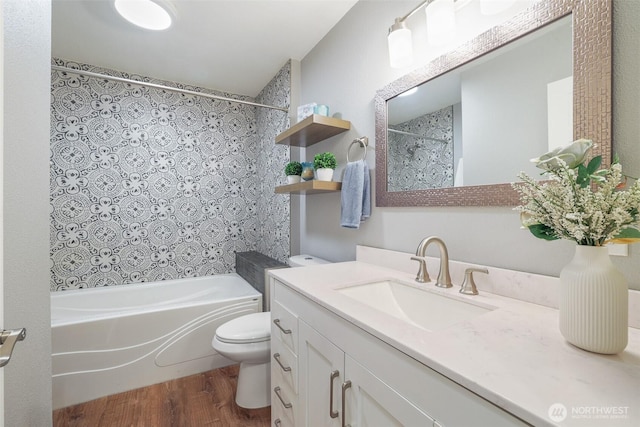 bathroom with toilet, shower / bath combo, wood finished floors, and vanity