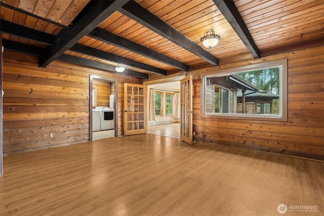 unfurnished living room featuring wooden ceiling, wood finished floors, french doors, wood walls, and beam ceiling