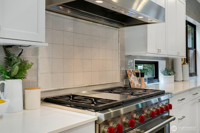 10906 SE 28th St, Bellevue, WA 98004 - kitchen featuring high end stove, decorative backsplash, exhaust hood, and light countertops