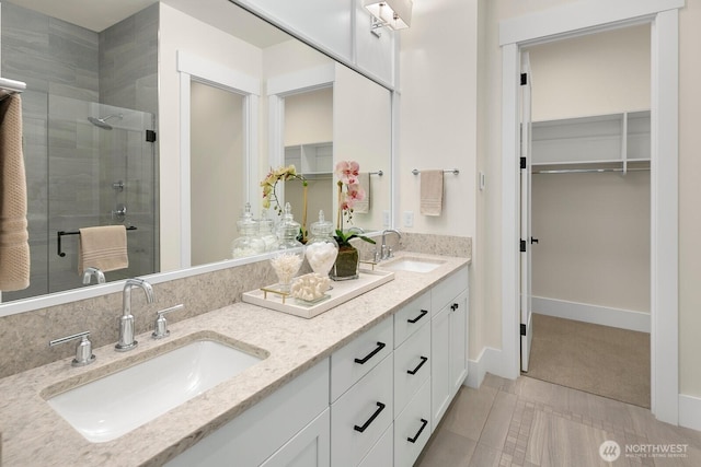 10906 SE 28th St, Bellevue, WA 98004 - full bathroom featuring a spacious closet, double vanity, a sink, and a stall shower
