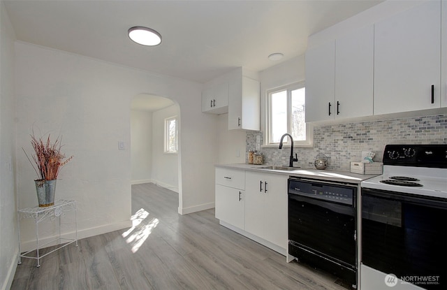 105 Redpath St, Kelso, WA 98675 - kitchen featuring range with electric cooktop, dishwasher, arched walkways, a sink, and tasteful backsplash