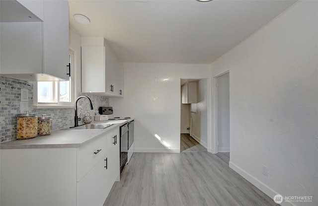 105 Redpath St, Kelso, WA 98675 - kitchen featuring a sink, light wood-style flooring, backsplash, white cabinets, and electric range