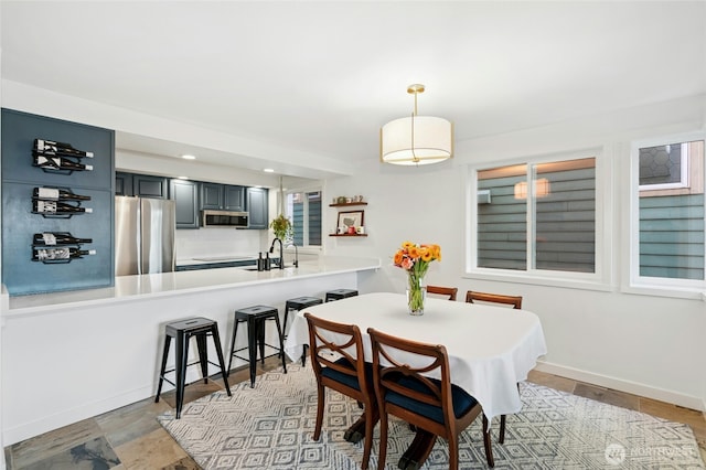 dining room featuring recessed lighting and baseboards