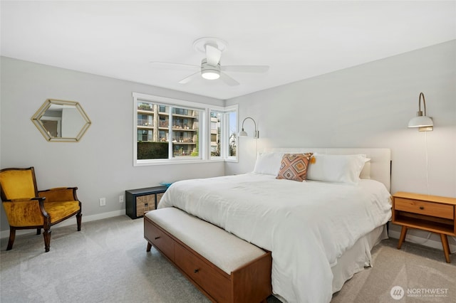 bedroom with light colored carpet, a ceiling fan, and baseboards