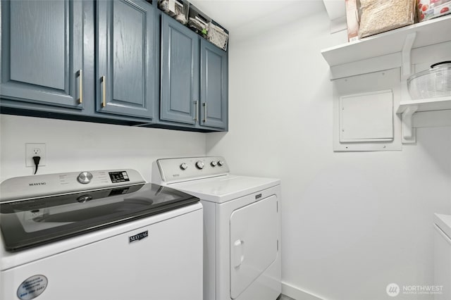 washroom featuring cabinet space and separate washer and dryer